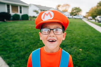Boy Standing on Green Grass
