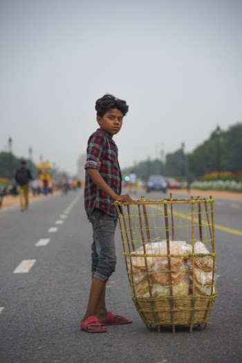 Boy Touching Brown Rattan Basket In The Middle Of Road