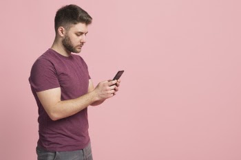 Boy using mobile phone Free Photo