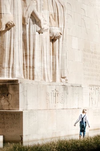 boy walking beside the statue