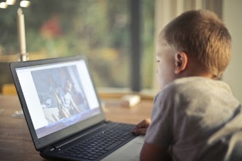 Boy Watching Video Using Laptop