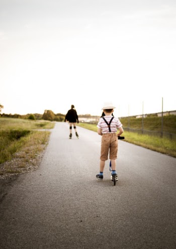 Boy Wearing White and Blue Short Riding Kick Scooter
