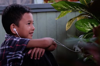 Boy Wearing White Earphones