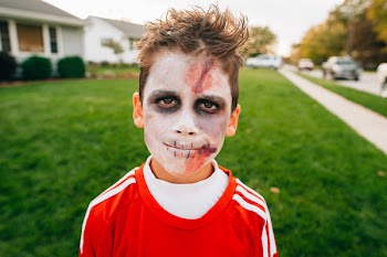 Boy With Zombie Makeup Standing Near White Concrete House