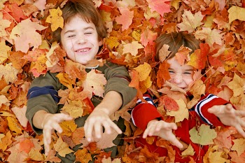 Boys Throwing Fall Leaves