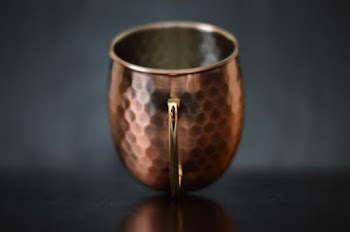Brass-colored Cup on Selective Focus Photography
