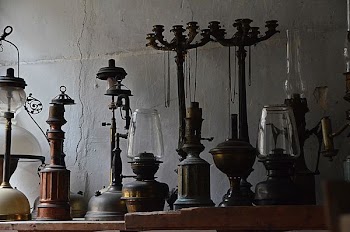 brass-colored oil lamps on top of table