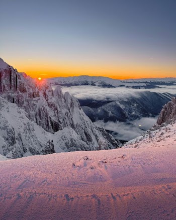 Breathtaking Winter Sunrise Over Snow-Capped Mountains