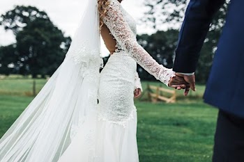 bride and groom holding hans