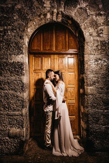 Bride And Groom Kissing Gesture In Front Of A Wooden Door