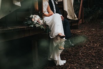 bride and groom sitting and holding their hands