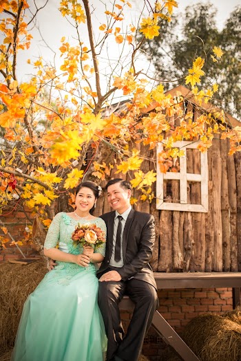 Bride and Groom Sitting on Wooden Chair