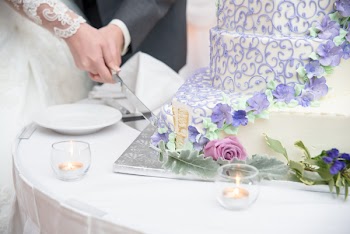 Bride And Groom Slicing Cake