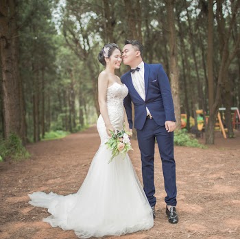 Bride and Groom Standing Between Trees
