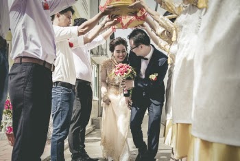 Bride and Groom Walking Between People Standing