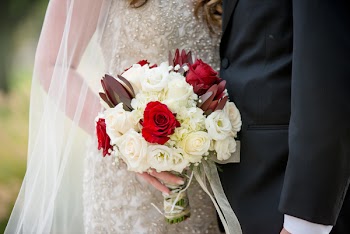 Bride Holding Bouquet of Flowers Beside Groom