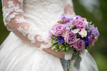 Bride Holding Bouquet Of Roses