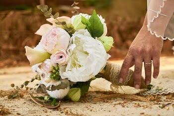 Bride Picking Up Pink and White Flower Bouquet