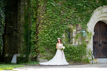 Bride Standing Beside Green Vines
