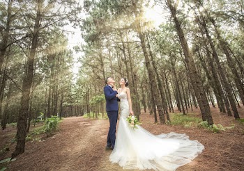 Bridge and Groom Standing in Middle of Trees