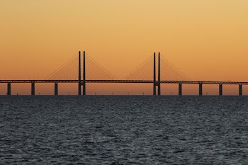 bridge during sunset with body of water
