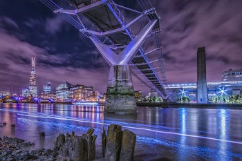 bridge over the river connected to city at night time