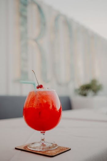 Bright red cocktail with cherry and straw · Free Stock Photo