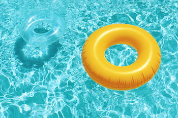 Bright Yellow Inflatable Swim Ring in Turquoise Pool