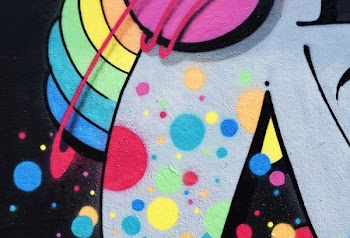 Brightly colored urban street art graffiti mural at Photo Week