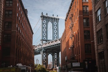 Brooklyn Bridge Seen in Between Brown Buildings
