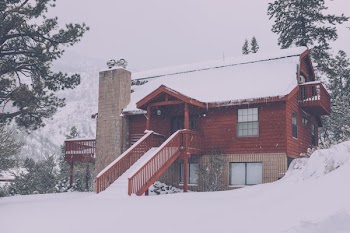 brown 2-storey house covered with snow