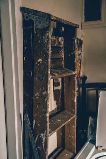 Brown A-frame Ladder in Front of White Painted Wall