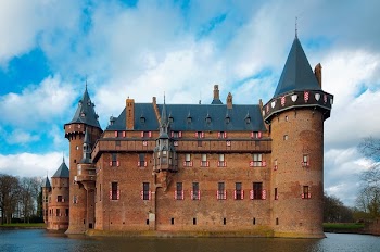 Brown and Black Castle Surrounded by Body of Water