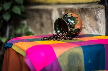 Brown and Black Ceramic Coffee Bean Rack on Pink Green and Yellow Textile
