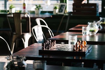 brown and black chess board on brown wooden table