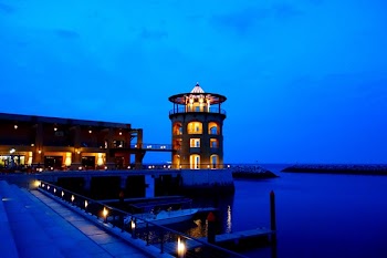 Brown and Black Concrete Building Near Body of Water