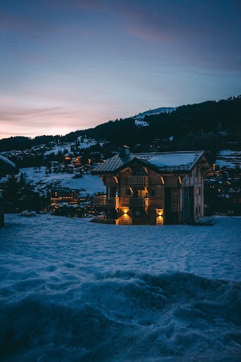 Brown and Black Wooden Chalet House In A Snowy Mountain
