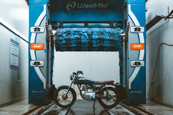 Brown and Blue Cafe Racer Parked Beside Washtec Vehicle Washer
