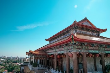 Brown and Gray Concrete Pagoda Under White Clouds and Blue Sky
