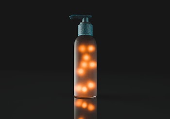 Brown and Gray Lighted Pump Bottle With Black Background