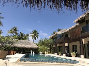Brown and White Concrete 2-storey House Near Swimming Pool