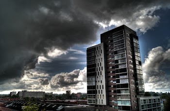 Brown and White Concrete Building Under Cloudy Sky
