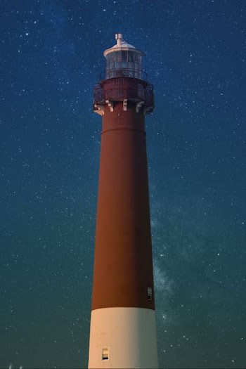 brown and white lighthouse during nighttime