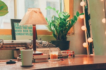 Brown and White Table Lamp on Wooden Table Near Window