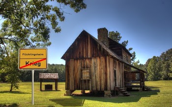 Brown Barnhouse Beside Signage and Tree