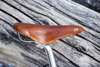 brown bike seat on plank