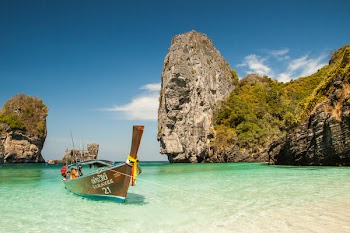 Brown Boat on Body of Water Nduring Day Time