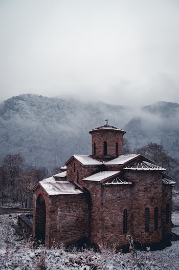 Brown Brick Church Near Mountains In Winter 