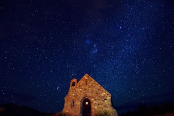brown brick house under starry night