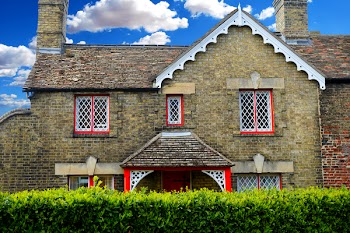 Brown Brick House Under White Clouds